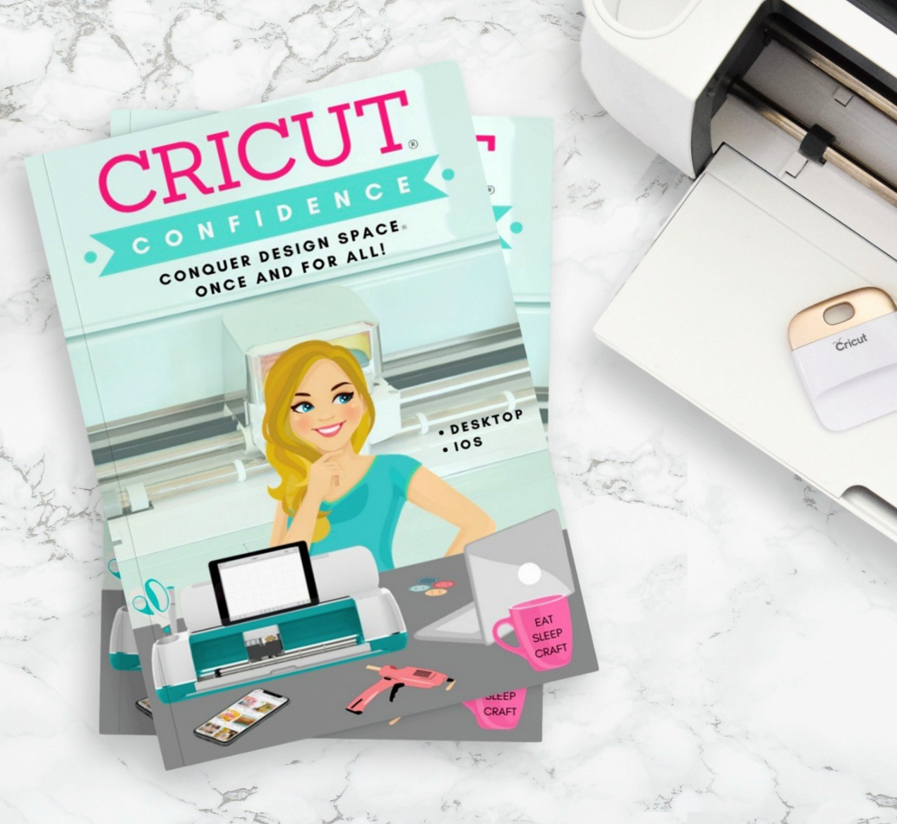 Cricut Confidence book stack next to a Cricut machine 